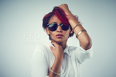 Buy stock photo Portrait, fashion and woman with sunglasses, confidence and person on gray studio background. Face, model and girl with stylish clothes, hair dye and mockup space with pride, punk rock and gen z