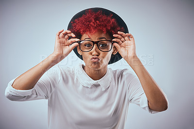 Buy stock photo Silly, pout and portrait of woman in studio with funny face for emotion, facial expression or emoji reaction. Redhead, glasses and isolated person with confidence, hat and goofy on white background