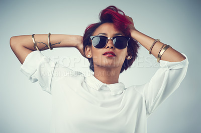 Buy stock photo Stylish, woman and portrait with sunglasses in studio for summer outfit, fashion and confidence. Female person, clothes and shades with pride by gray background for trendy, eyewear and cool accessory