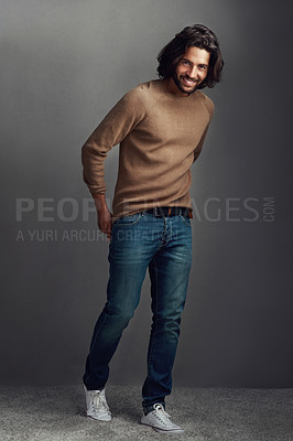 Buy stock photo Smile, man and portrait with fashion in studio for elegant, style and comfortable winter jeans clothes. Cool, male person and trendy jersey, designer wardrobe or hands in pocket on grey background