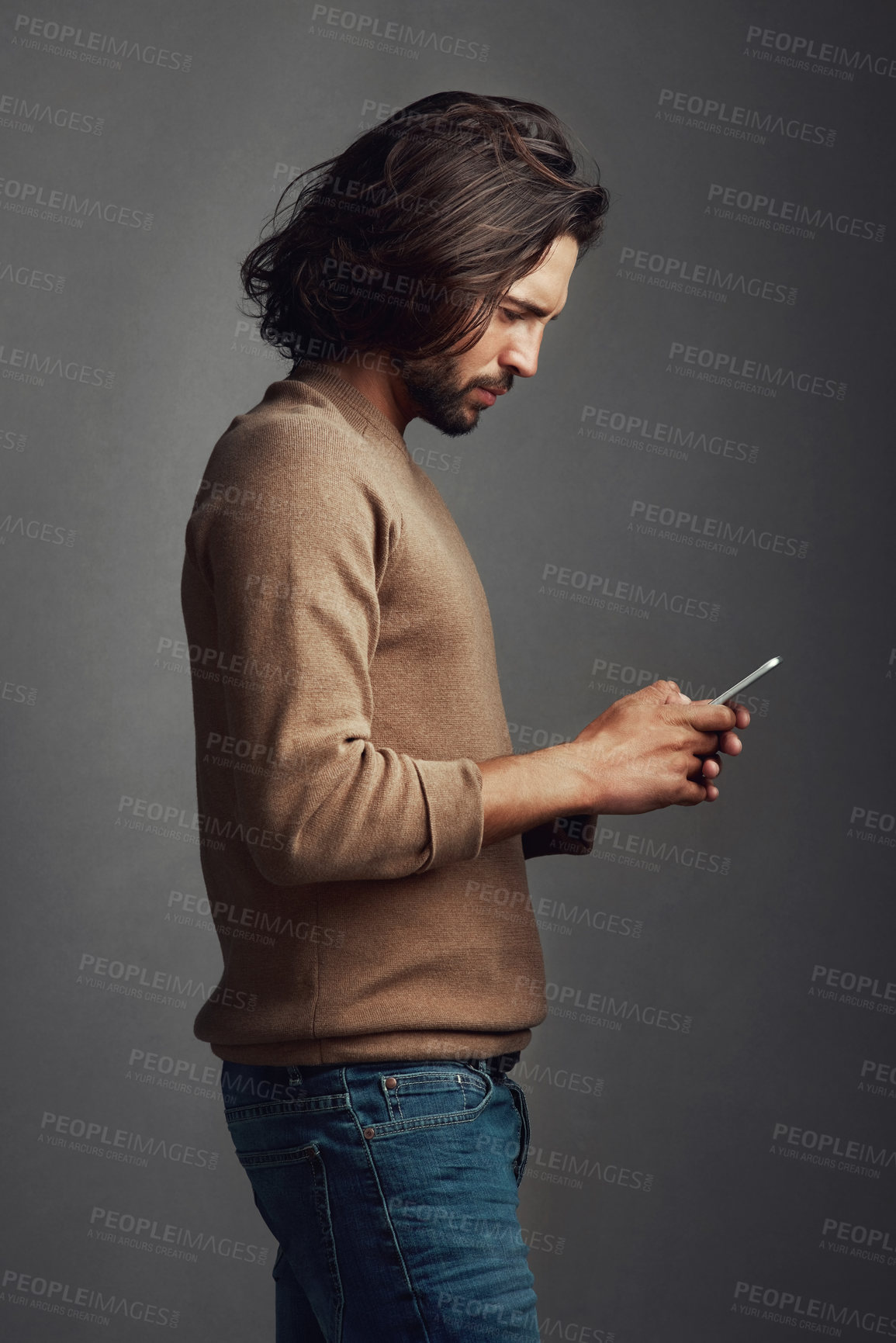 Buy stock photo Man, phone internet and communication with reading email, social media post and website for ebook download in studio. Guy, mobile and typing for online puzzle, text app and network by gray background