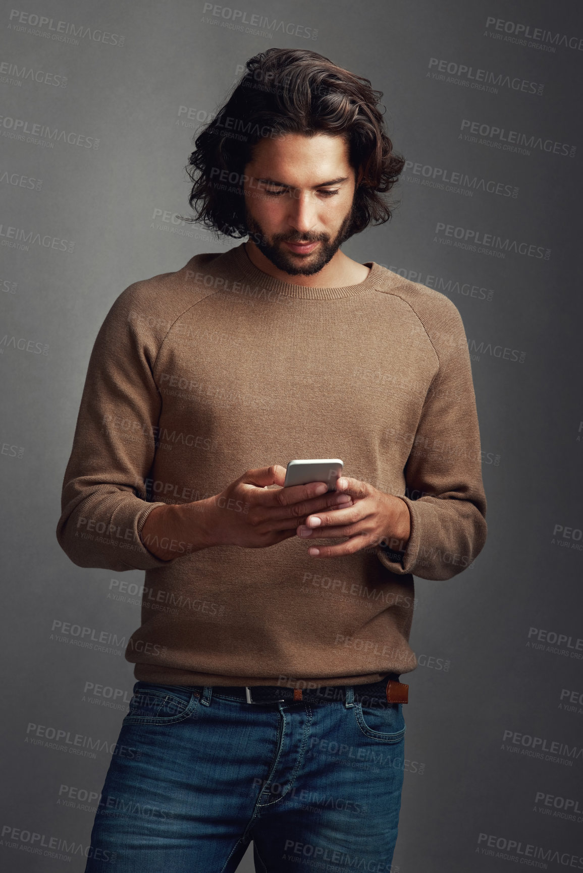 Buy stock photo Man, smartphone and reading blog in studio for research, ebook and online or mobile app. Technology, male model and website or internet for networking and social media or typing by dark background