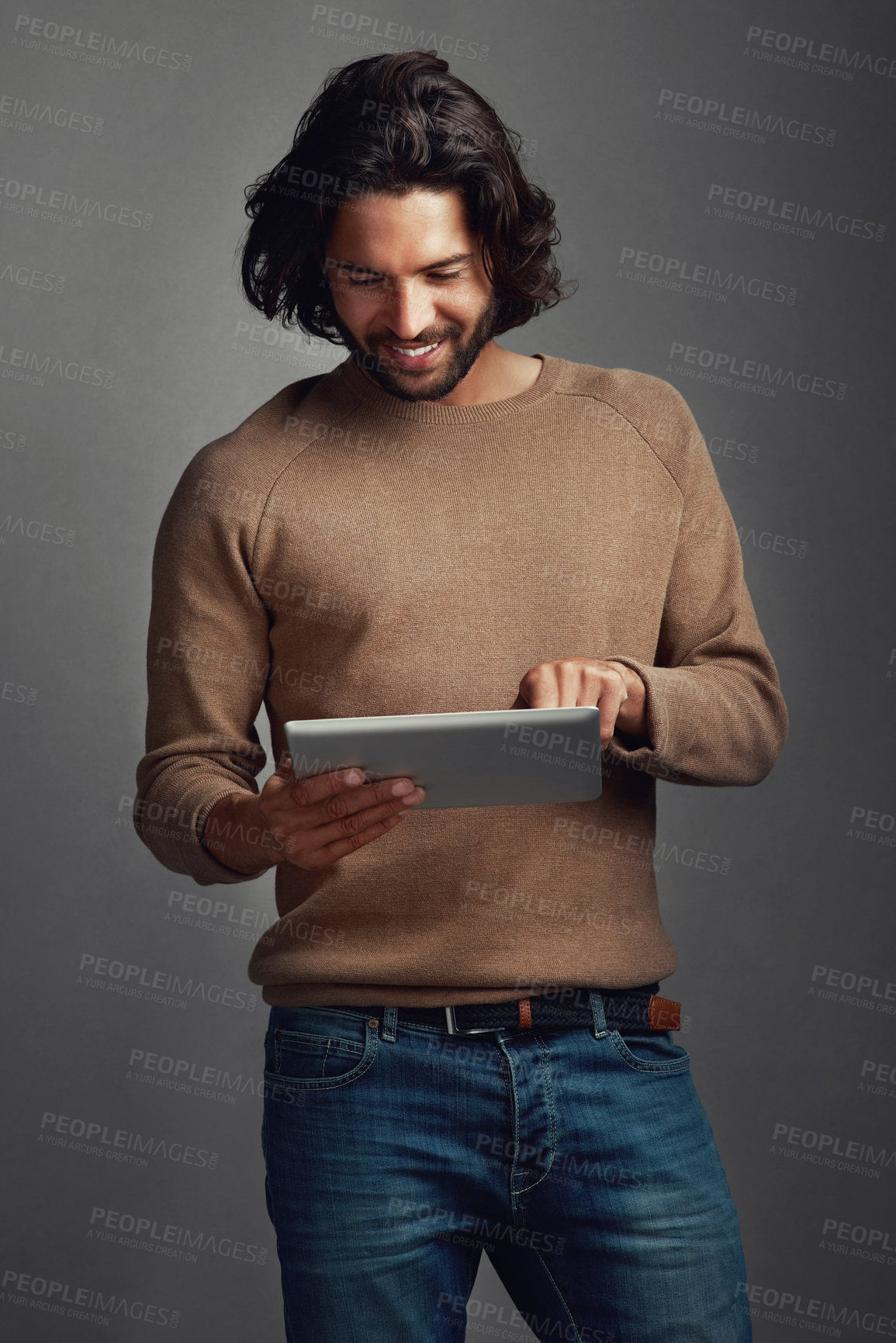 Buy stock photo Tablet, reading and happy man in studio online for social media, dating app and email notification. Digital technology, scroll and person on website for fashion blog info isolated on gray background