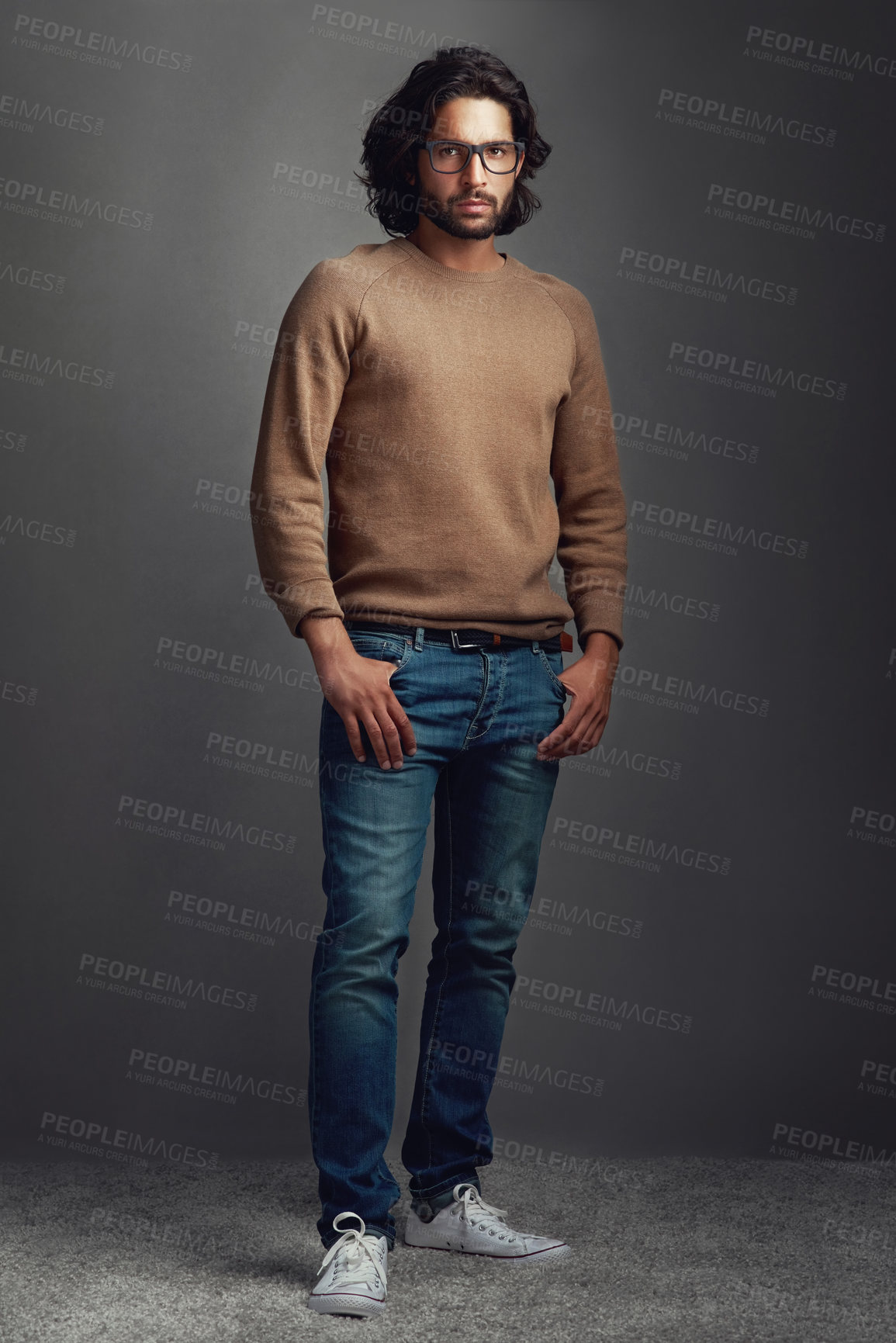 Buy stock photo Fashion, serious and man for portrait in studio with elegant style, comfortable or winter jeans clothes. Smart, male person and trendy jersey, designer glasses or hands in pocket on grey background