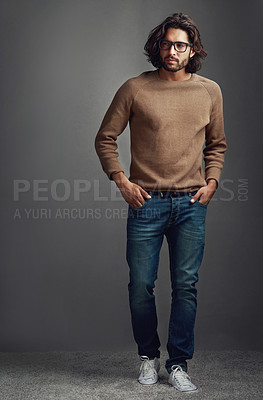 Buy stock photo Thinking, serious man and fashion for portrait in studio, ideas for elegant style of comfortable jeans clothes. Serious, male person and trendy jersey, glasses or hands in pocket on grey background