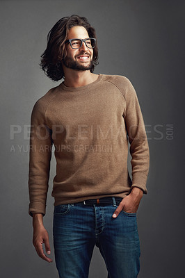 Buy stock photo Studio shot of a handsome young man posing against a gray background