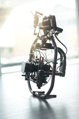 Buy stock photo Behind the scenes shot of a state of the art video camera placed on the floor of a studio during the day
