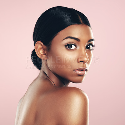 Buy stock photo Studio portrait of a beautiful young woman posing against a pink background