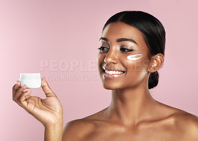 Buy stock photo Skincare, smile and woman with cream container in studio isolated on a pink background. Product, dermatology creme and Indian female model holding lotion, moisturizer and cosmetics for healthy skin.