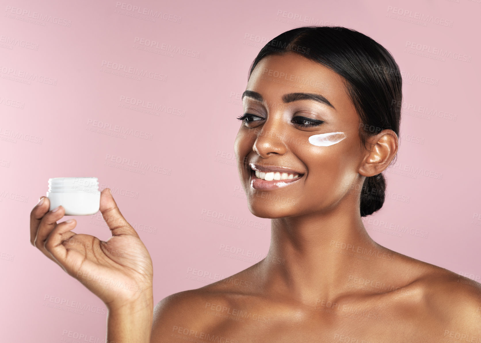 Buy stock photo Skincare, smile and woman with cream container in studio isolated on a pink background. Product, dermatology creme and Indian female model holding lotion, moisturizer and cosmetics for healthy skin.