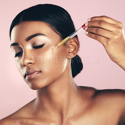 Buy stock photo Face, skincare serum and woman with eyes closed in studio isolated on a pink background. Dermatology, cosmetics and Indian model with hyaluronic acid, essential oil or vitamin a for healthy skin.