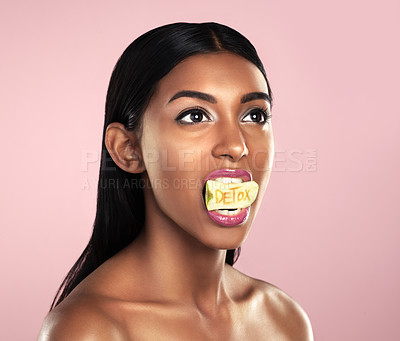 Buy stock photo Detox, fruit and woman with apple in her mouth for beauty empowerment isolated in a studio pink background. Skincare, food and female model or person on diet for self love or cosmetic care