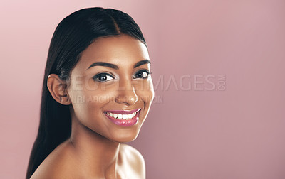 Buy stock photo Face portrait, skincare and smile of woman in studio isolated on a pink background mockup. Natural, beauty and Indian female model with makeup, cosmetics and spa facial treatment for healthy skin.
