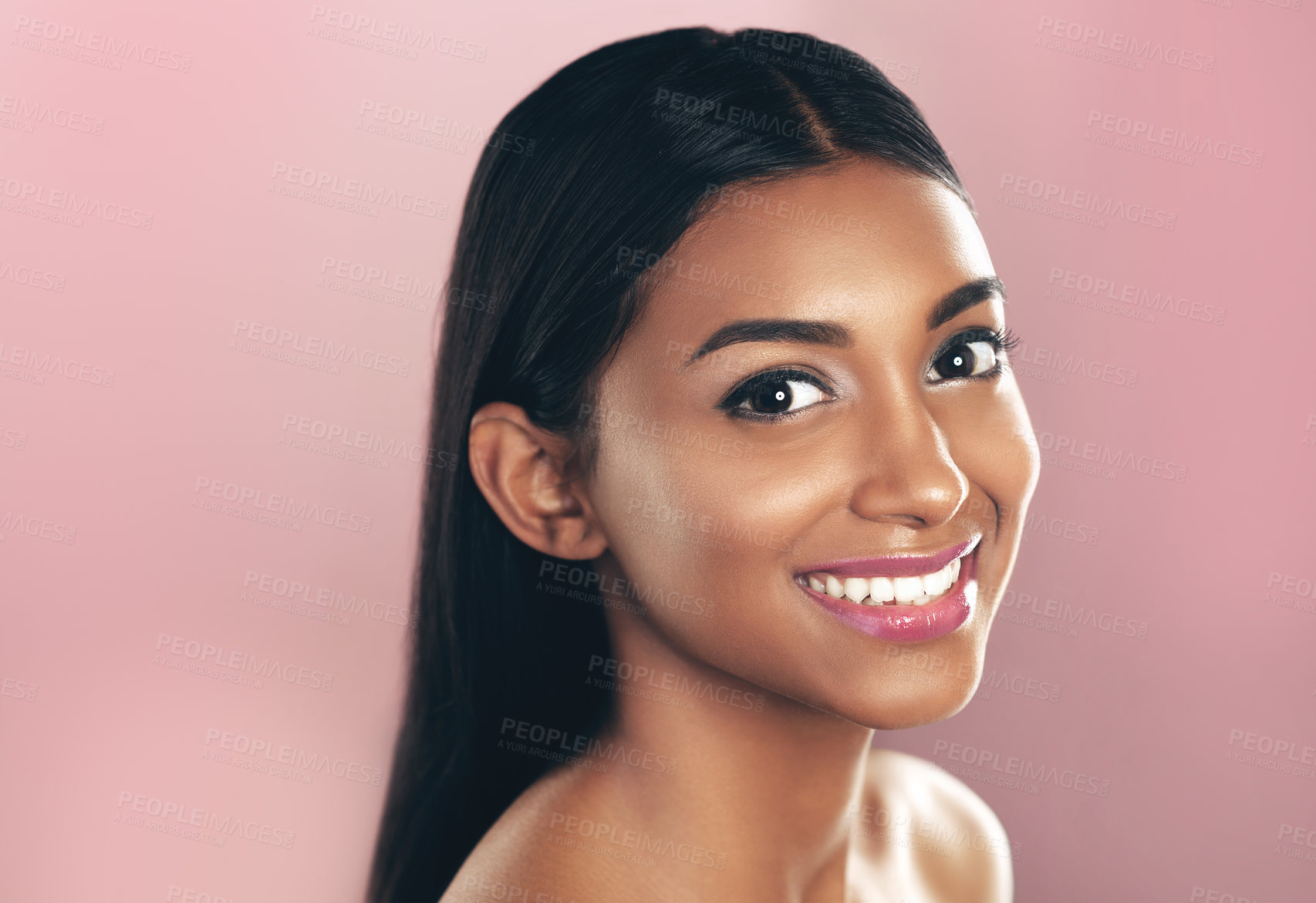 Buy stock photo Face portrait, skincare and happy woman in studio isolated on a pink background mockup space. Natural, beauty and Indian female model with makeup, cosmetics and spa facial treatment for healthy skin.