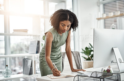 Buy stock photo Computer, planning and business woman writing and working by her desk or table in a corporate startup company. Internet, online and professional female employee or African worker with a schedule book
