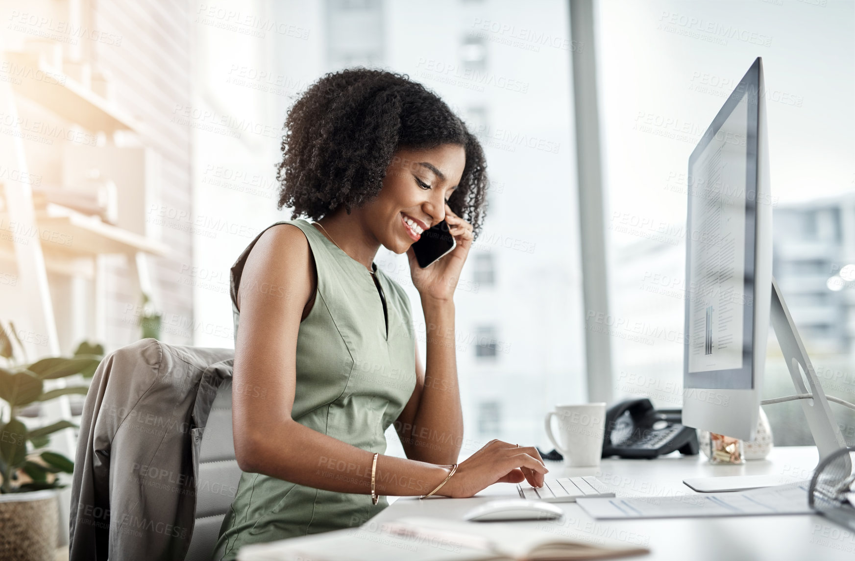 Buy stock photo Shot of a young businesswoman using a mobile phone at her desk in a modern office