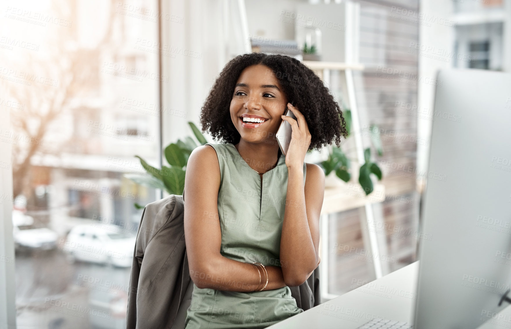 Buy stock photo Phone call, conversation and African woman in modern office for communication, tech and talking. Black female designer, desktop and mobile discussion for client feedback, thinking and project ideas