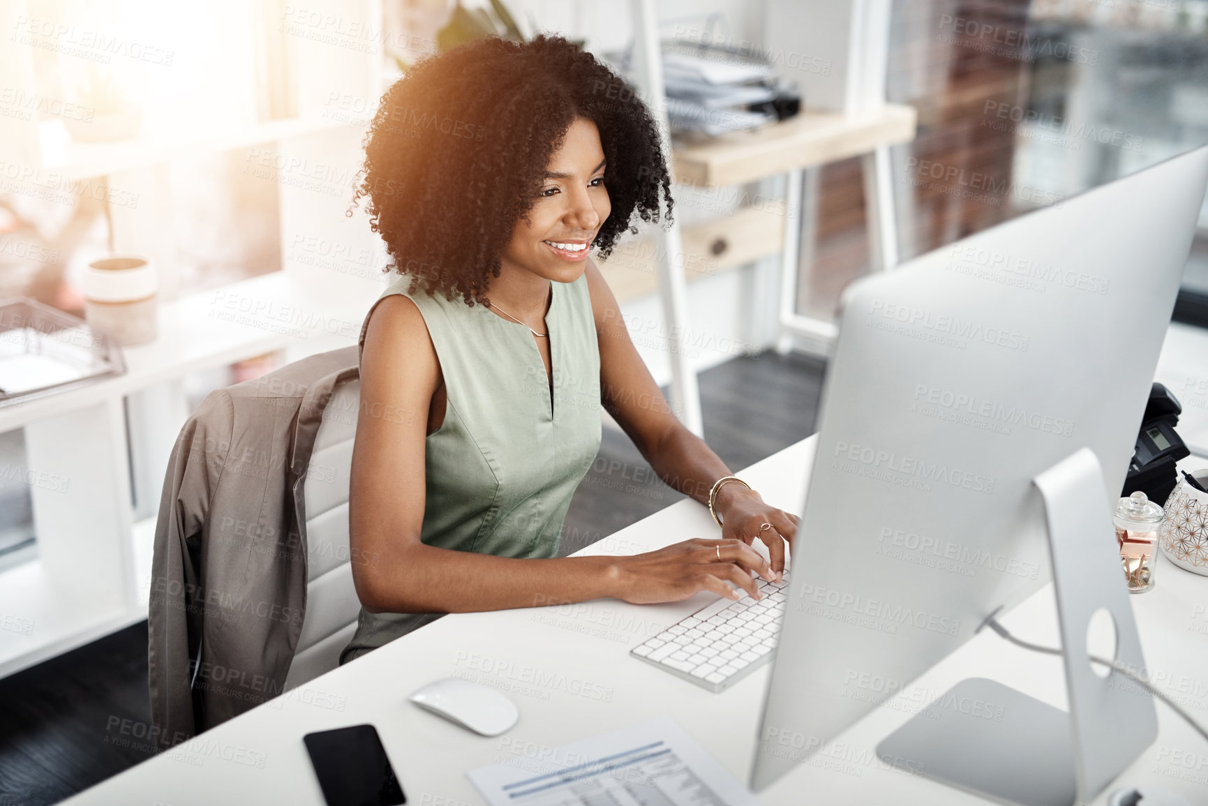 Buy stock photo Shot of a young businesswoman working at her desk in a modern office