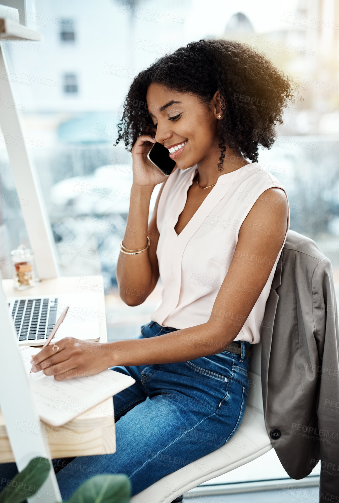 Buy stock photo High angle shot of an attractive young businesswoman busy on a phonecall while working in her home office