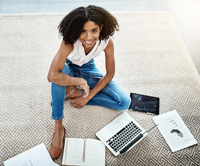 Buy stock photo High angle portrait of an attractive young businesswoman sitting on the floor while working in her home office