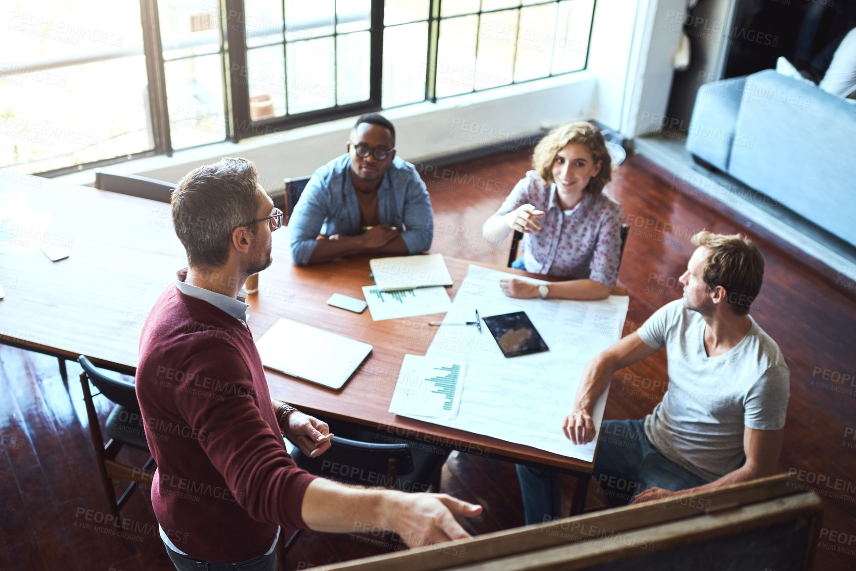 Buy stock photo Business, group and meeting for presentation in office for brainstorming, ideas and solution of sales growth. Above, team and speaker for finance, discussion and documents for feedback of profit goal