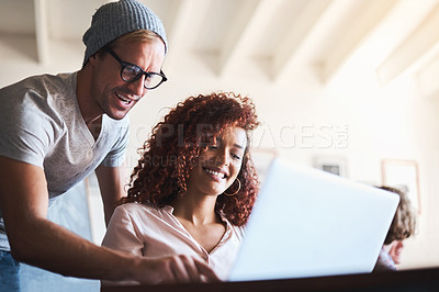 Buy stock photo Cropped shot of two designers discussing something on a laptop