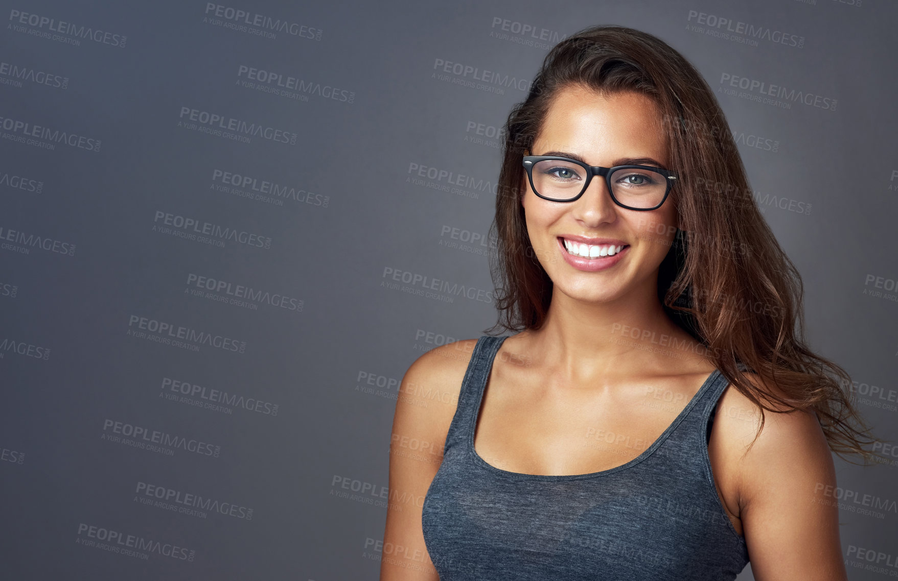 Buy stock photo Woman, portrait and excited with eyeglasses in studio on grey background for prescription, eyewear and eyesight. Mockup space, happy and satisfied or confident on frame for spectacles, lens or vision