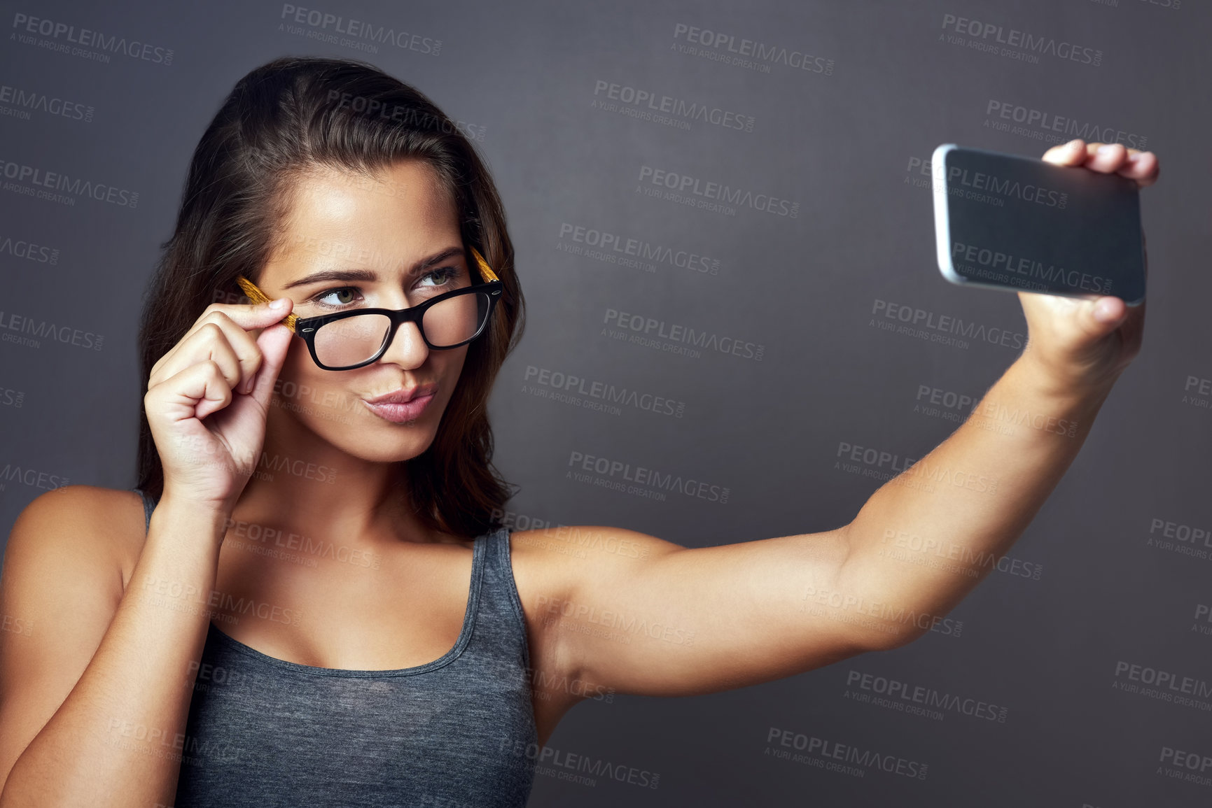 Buy stock photo Glasses, pout and selfie with influencer woman in studio for social media status post or update. Eyewear, photograph and smile with happy person on gray background for mobile profile picture