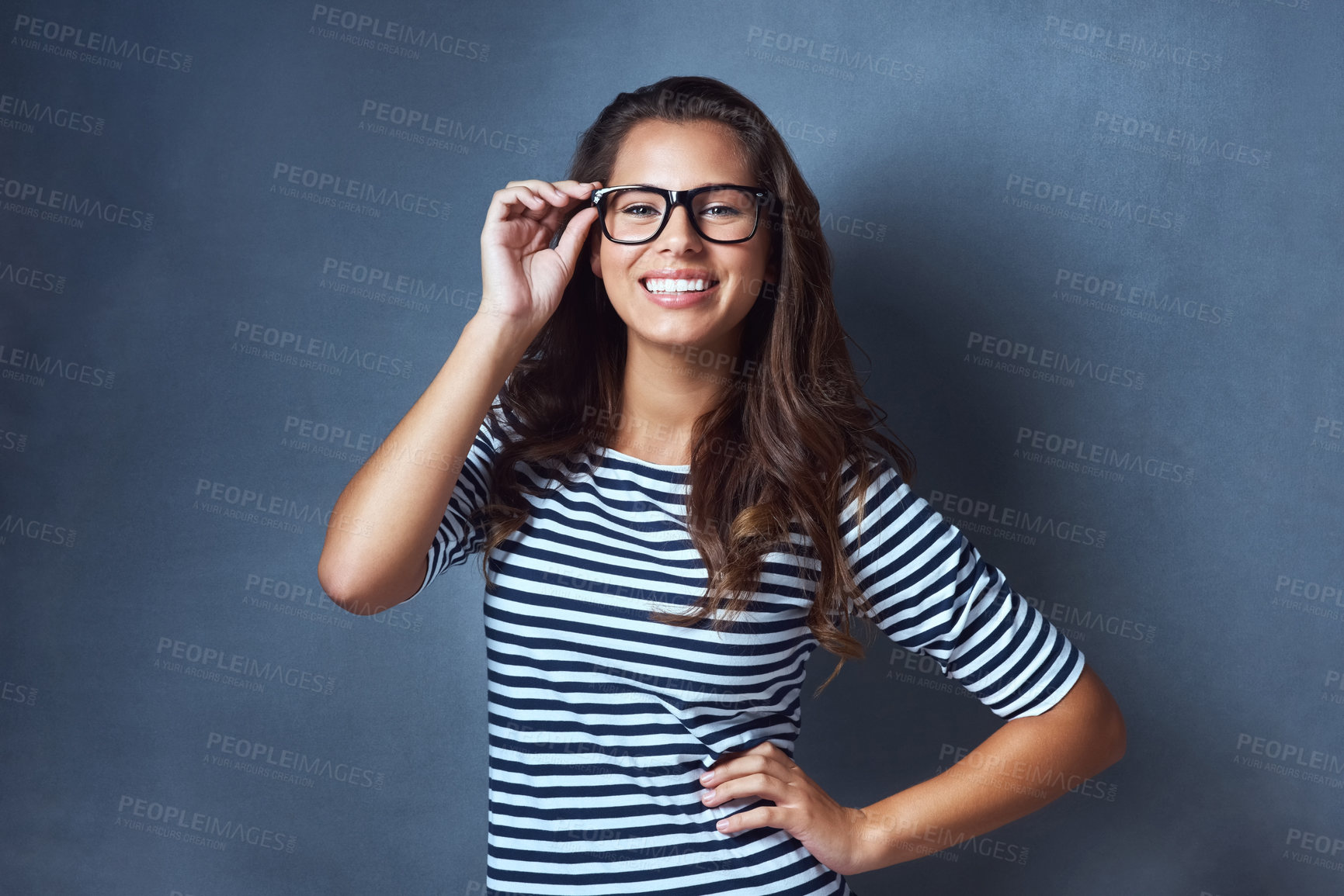 Buy stock photo Girl, portrait and happy with glasses in studio with prescription lens for eye care, optometry and healthcare. IT professional, confident and blue background with spectacles for vision and space.