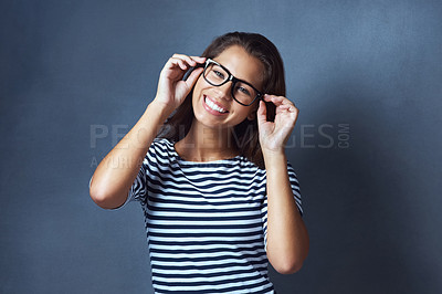 Buy stock photo Woman, portrait and glasses in studio for eye care with prescription lens for eyesight, optometry or healthcare. Female IT professional, happy and blue background with spectacles for vision and space