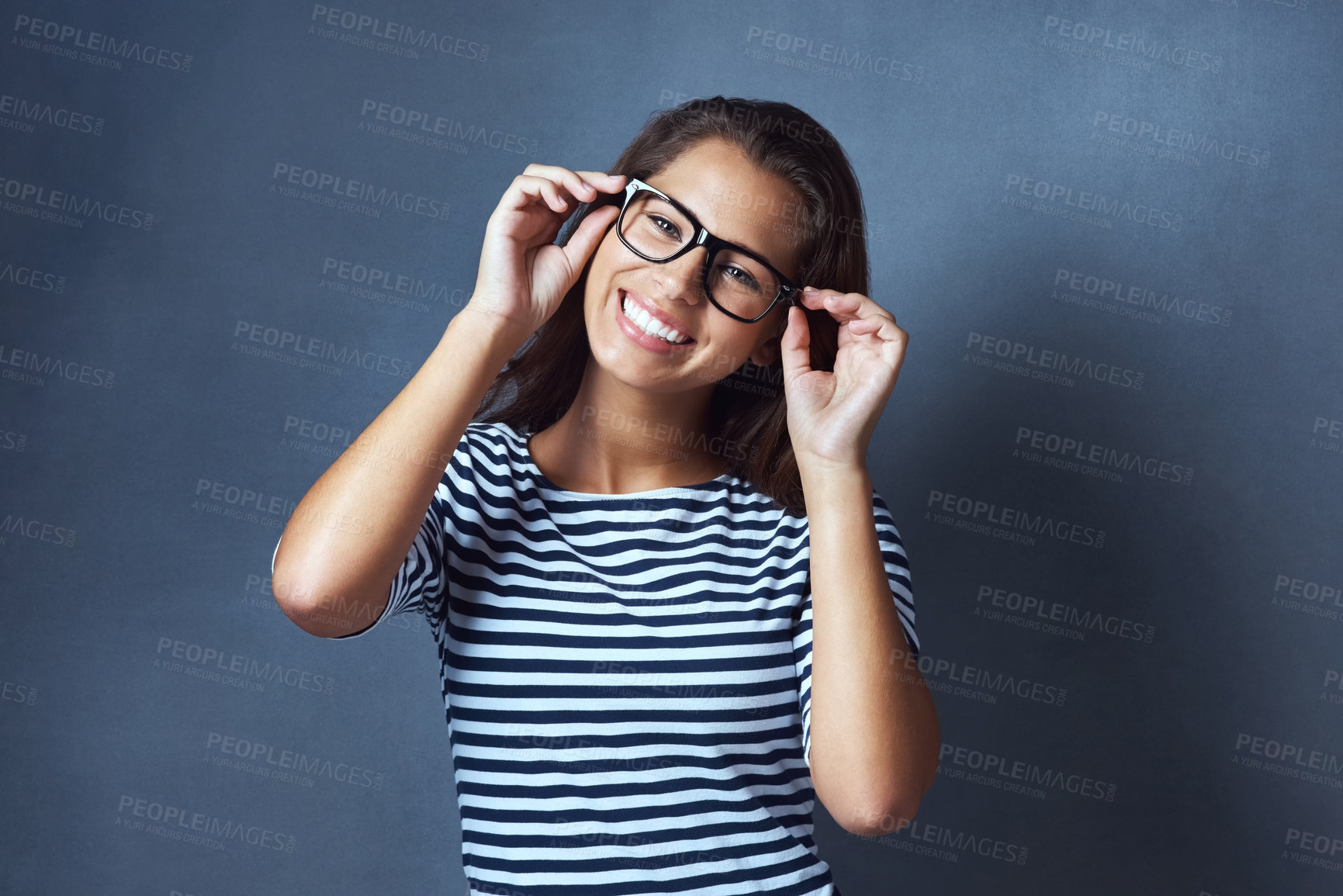 Buy stock photo Woman, portrait and glasses in studio for eye care with prescription lens for eyesight, optometry or healthcare. Female IT professional, happy and blue background with spectacles for vision and space