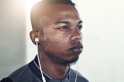 Buy stock photo Fitness, earphones and man with thinking for exercise, workout planning and wellness podcast. Male person, serious and idea with headphones for music, audio streaming and cardio training in morning