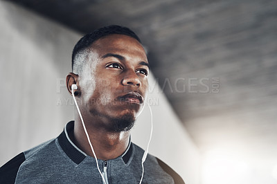 Buy stock photo Exercise, earphones and man with thinking for fitness, training planning and workout podcast. Male person, serious and idea with headphones for streaming, music and cardio for wellness in low angle