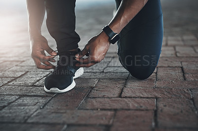 Buy stock photo Person, hand and shoes for running or lace on ground for exercise fitness or cardio, training or performance. Feet, fingers and street as health athlete for workout challenge, marathon or sneakers