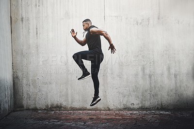 Buy stock photo Jump, training and black man running, speed and energy for cardio fitness, workout and sports wellness or body health. Athlete, runner or person exercise on concrete wall, action run or moving in air