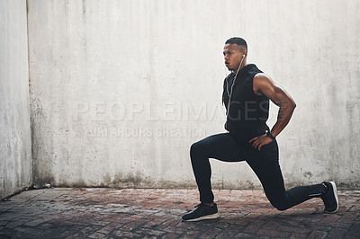 Buy stock photo Man, exercise and lunge with earphones in city for strong muscle, balance and mockup space by wall. African person, music and workout for legs with listening, health or audio streaming in New York