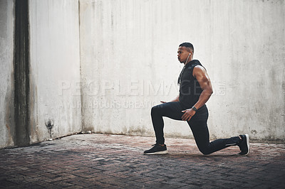 Buy stock photo Man, fitness and lunge with earphones in city for strong muscle, balance and exercise for wellness. African person, music and workout for legs with listening, health or audio streaming in New York