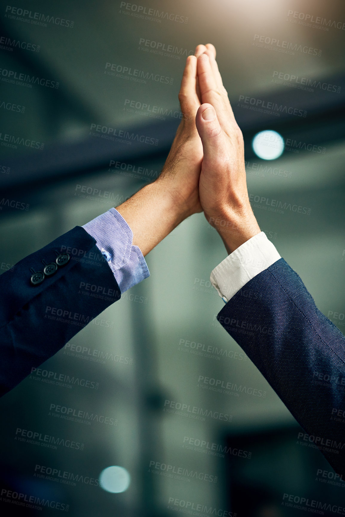 Buy stock photo Cropped shot of two unrecognizable businessmen high fiving in an office