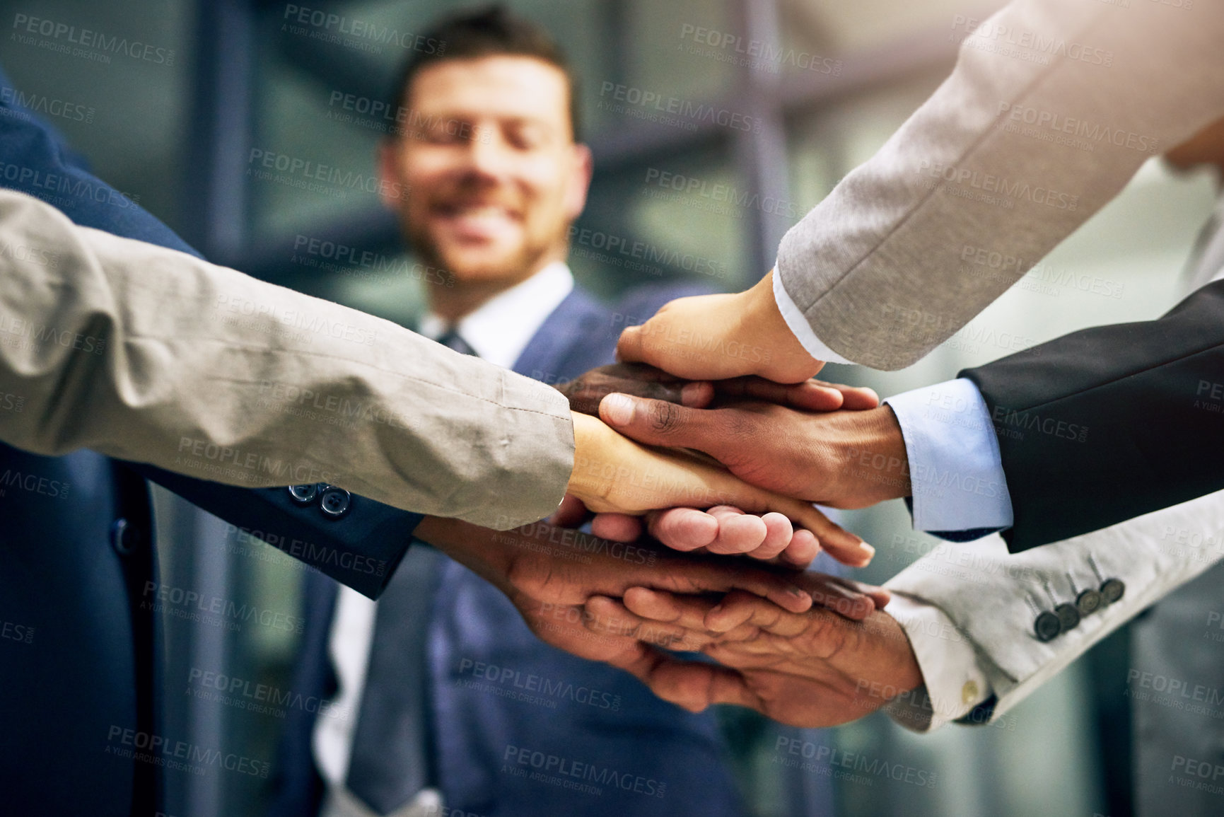 Buy stock photo Cropped shot of a group of businesspeople joining their hands together in unity