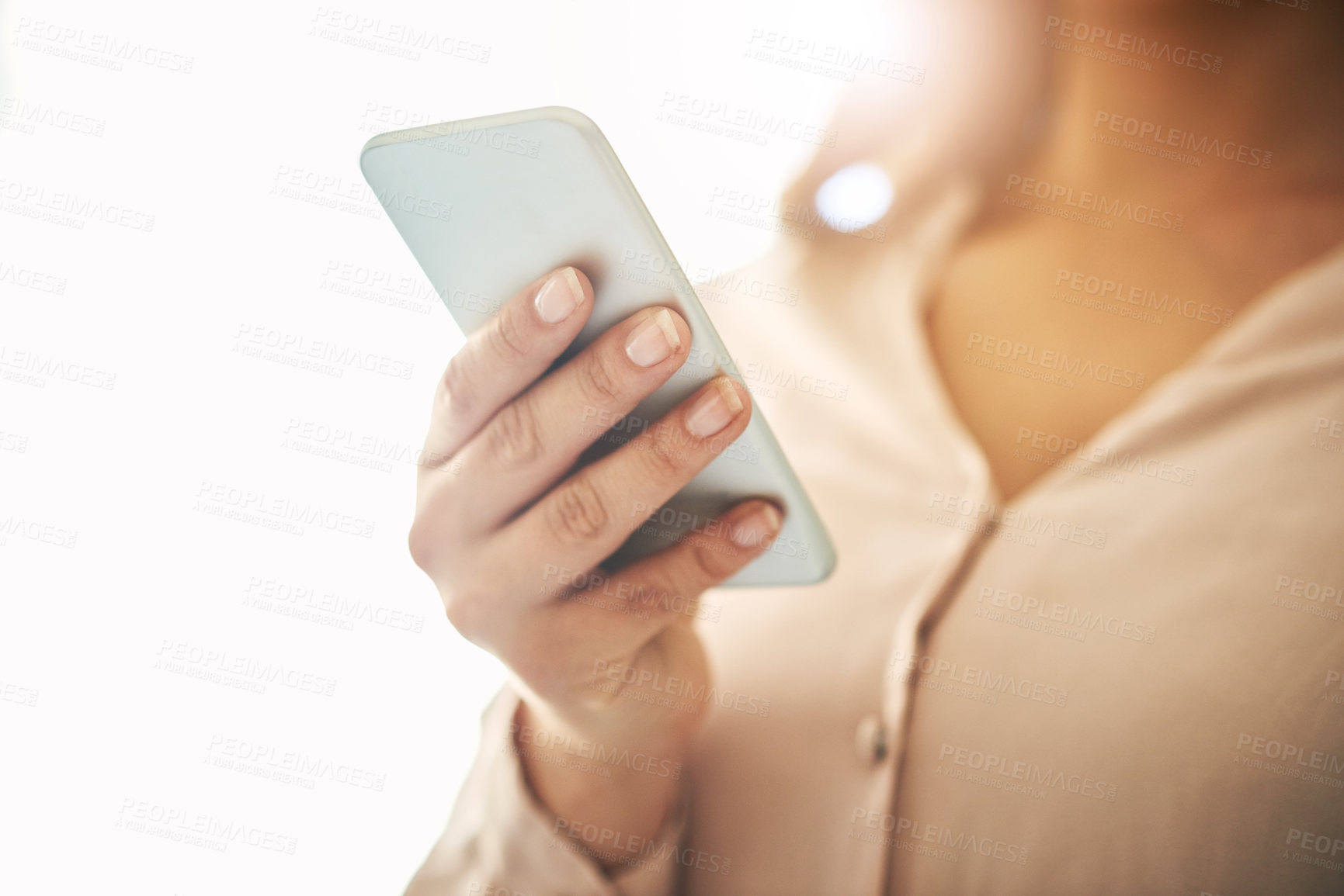 Buy stock photo Phone in hand, communication and networking with a woman reading, typing or sending a text message. Closeup of a female browsing social media, surfing the internet and checking news online with flare