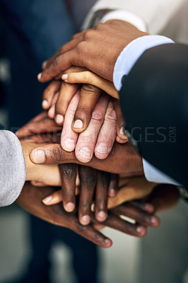 Buy stock photo High angle shot of a group of unrecognizable businesspeople joining their hands together in unity
