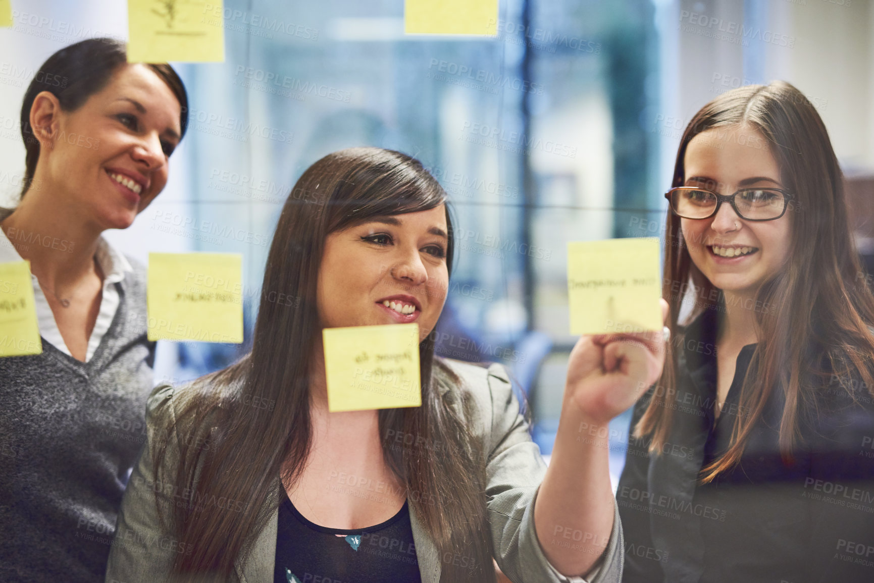 Buy stock photo Office, collaboration and business people with sticky note for planning, solution and discussion. Glass wall, women and mentor with writing for strategy, brainstorming and ideas for creative agency