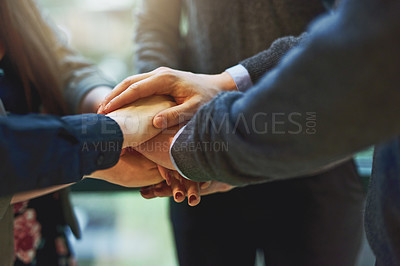 Buy stock photo Cropped shot of a group of unrecognizable businesspeople huddled together with their hands piled on top of each other in an office