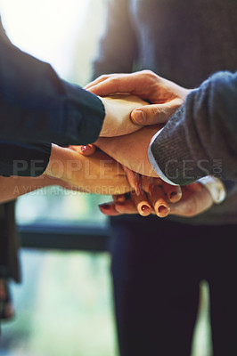 Buy stock photo Cropped shot of a group of unrecognizable businesspeople huddled together with their hands piled on top of each other in an office