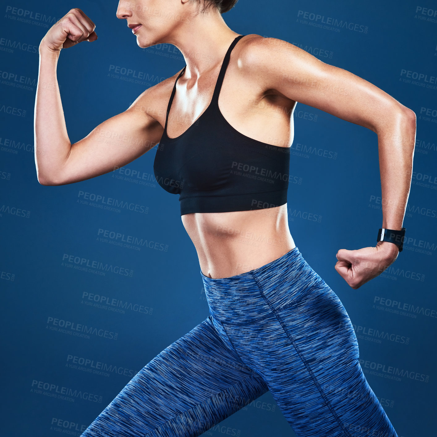 Buy stock photo Studio shot of an unrecognizable fit woman posing against a blue background