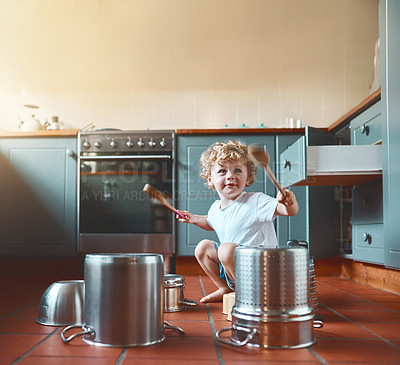Buy stock photo Portrait of an adorable little boy playing with pots in the kitchen