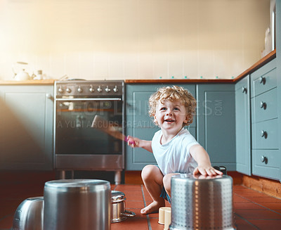 Buy stock photo Portrait of an adorable little boy playing with pots in the kitchen