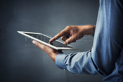 Buy stock photo Business person, hands and touching with tablet screen for digital innovation on a gray studio background. Closeup of employee scrolling on technology display for research, UI or UX on mockup space