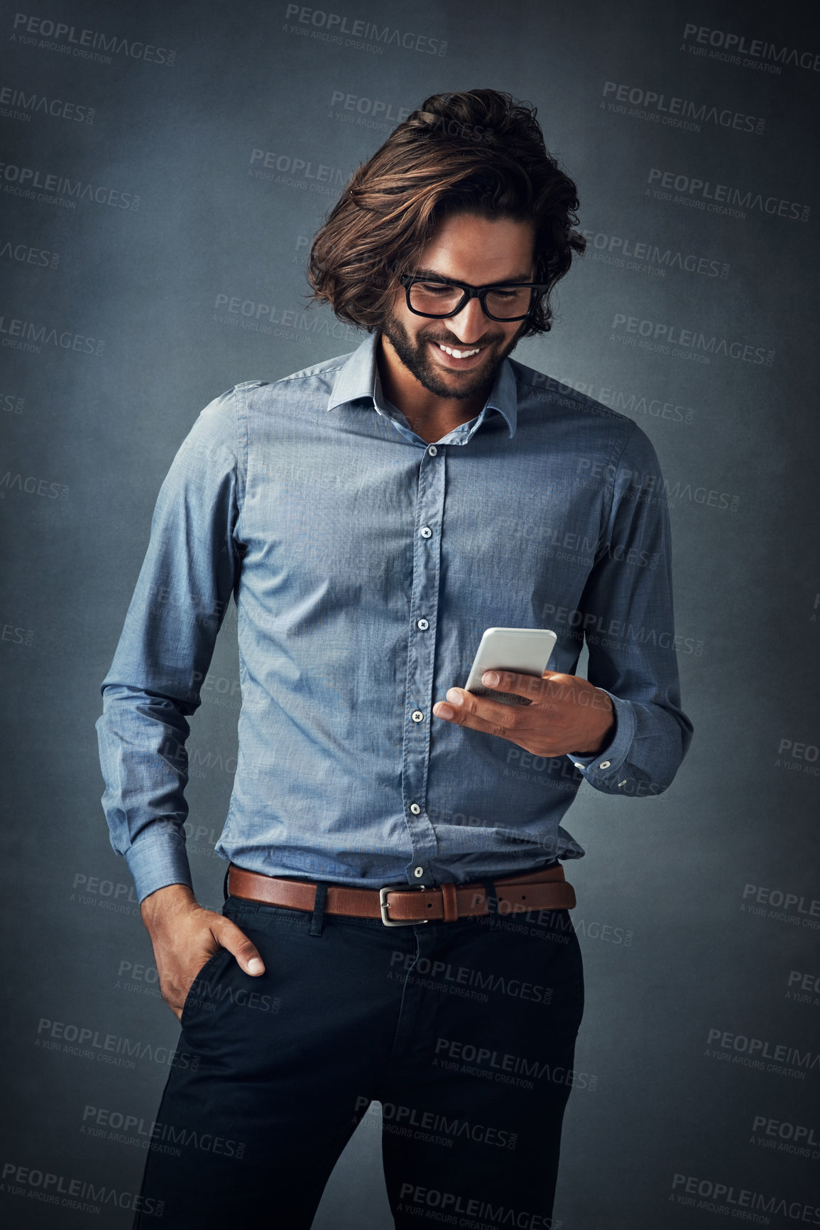 Buy stock photo Studio, business man and smile with mobile phone for chat, text message and online agreement with contact. Salesperson, glasses and reading on cellphone, social network and happy by gray background