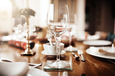 Buy stock photo Closeup shot of a wineglass on a table at Christmas